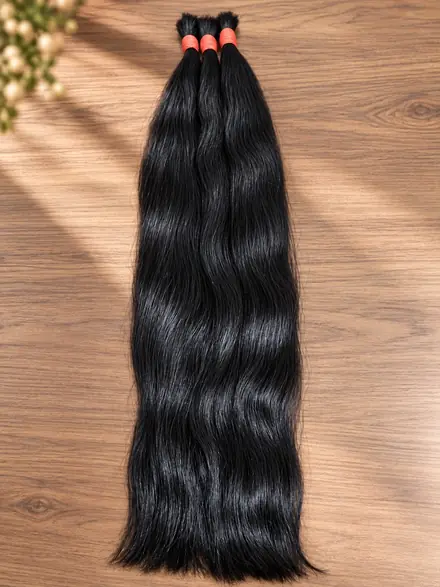 Três mechas de cabelo humano preto com onda natural e liga vermelha sobre mesa de madeira